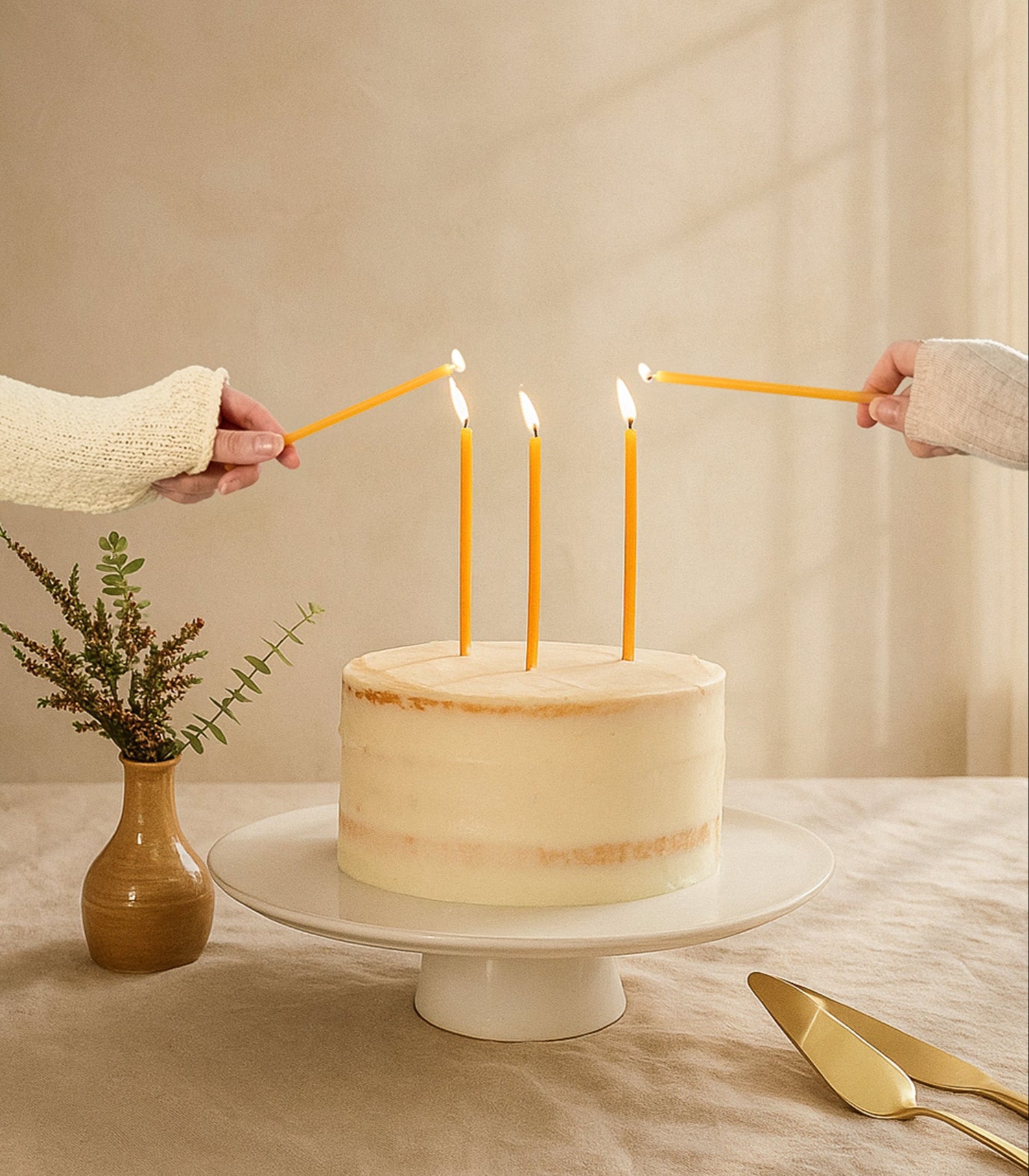 The Manifesting Studio beeswax birthday candles on a cake, designed for manifesting rituals and luxury celebrations.